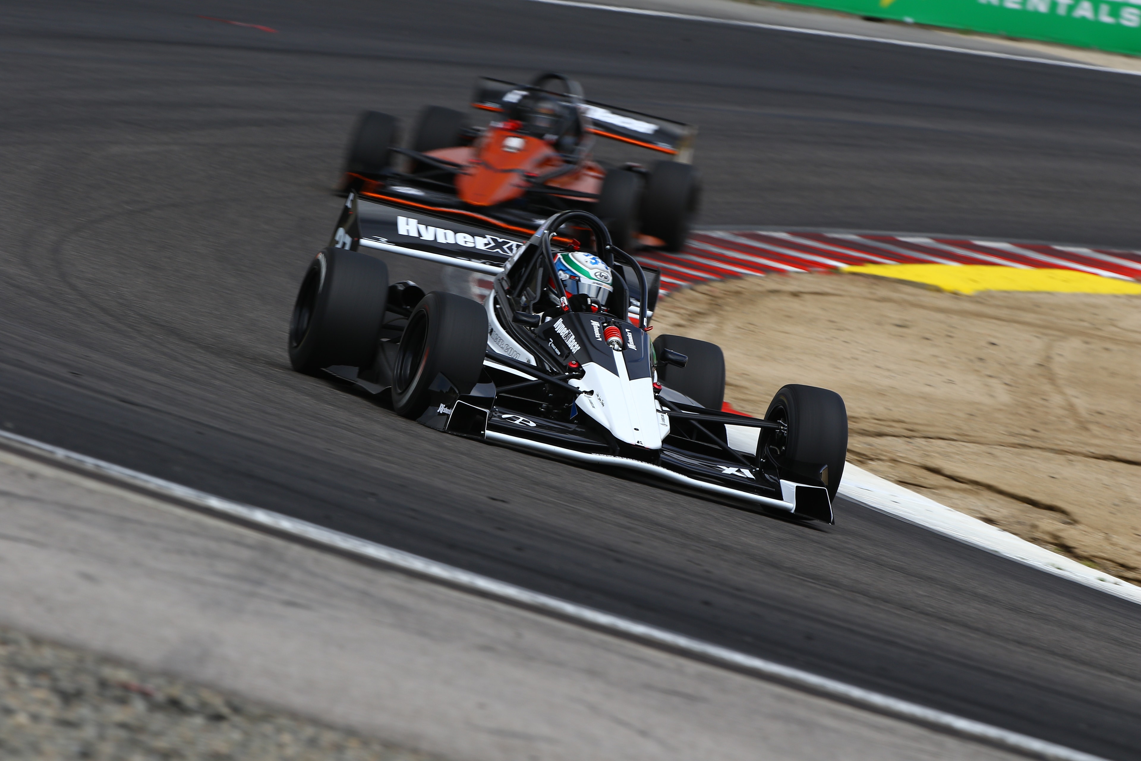 Three X1s in the Laguna Seca paddock
