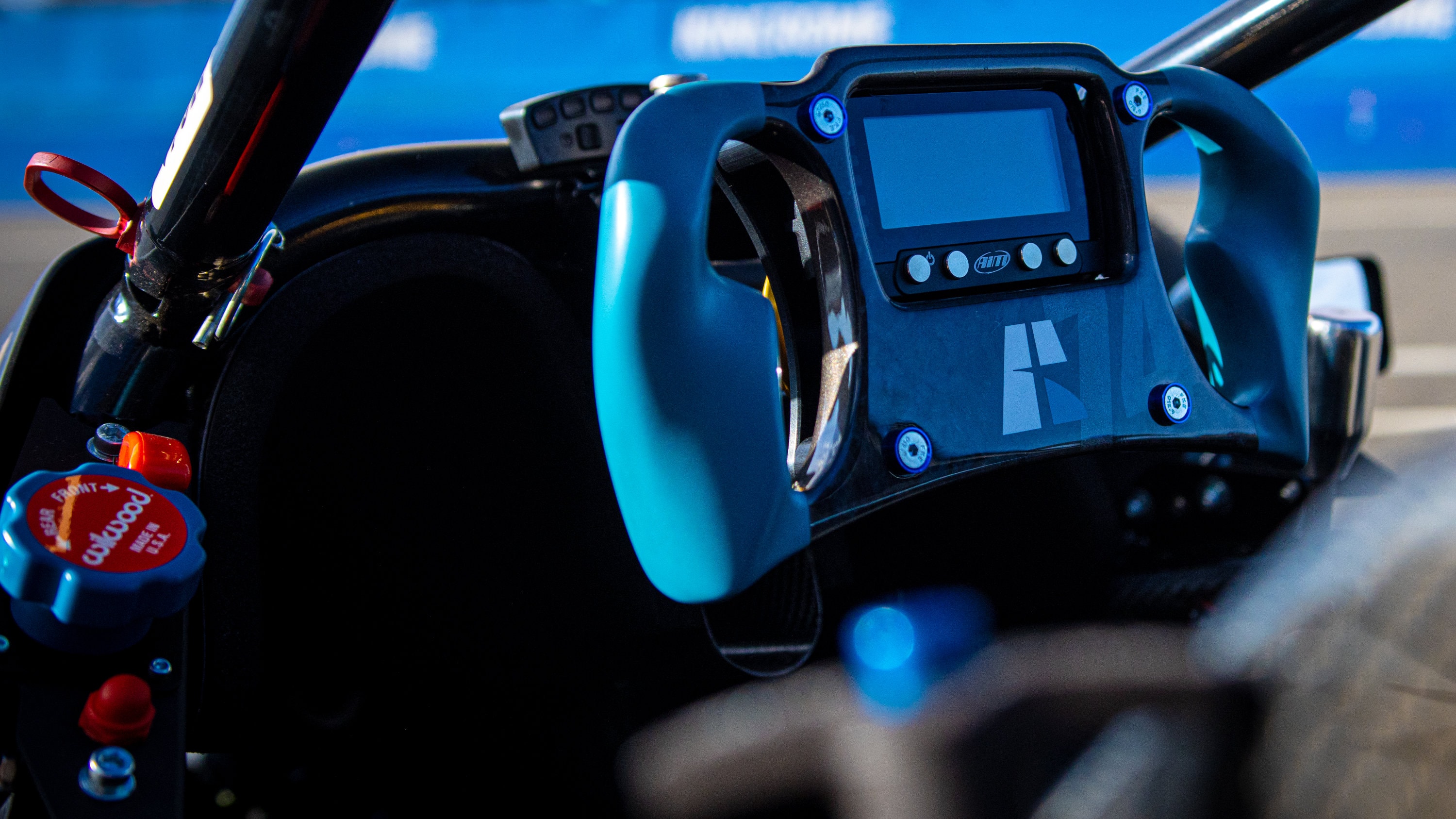 Blue X1 cockpit — AiM dash and Wilwood controls