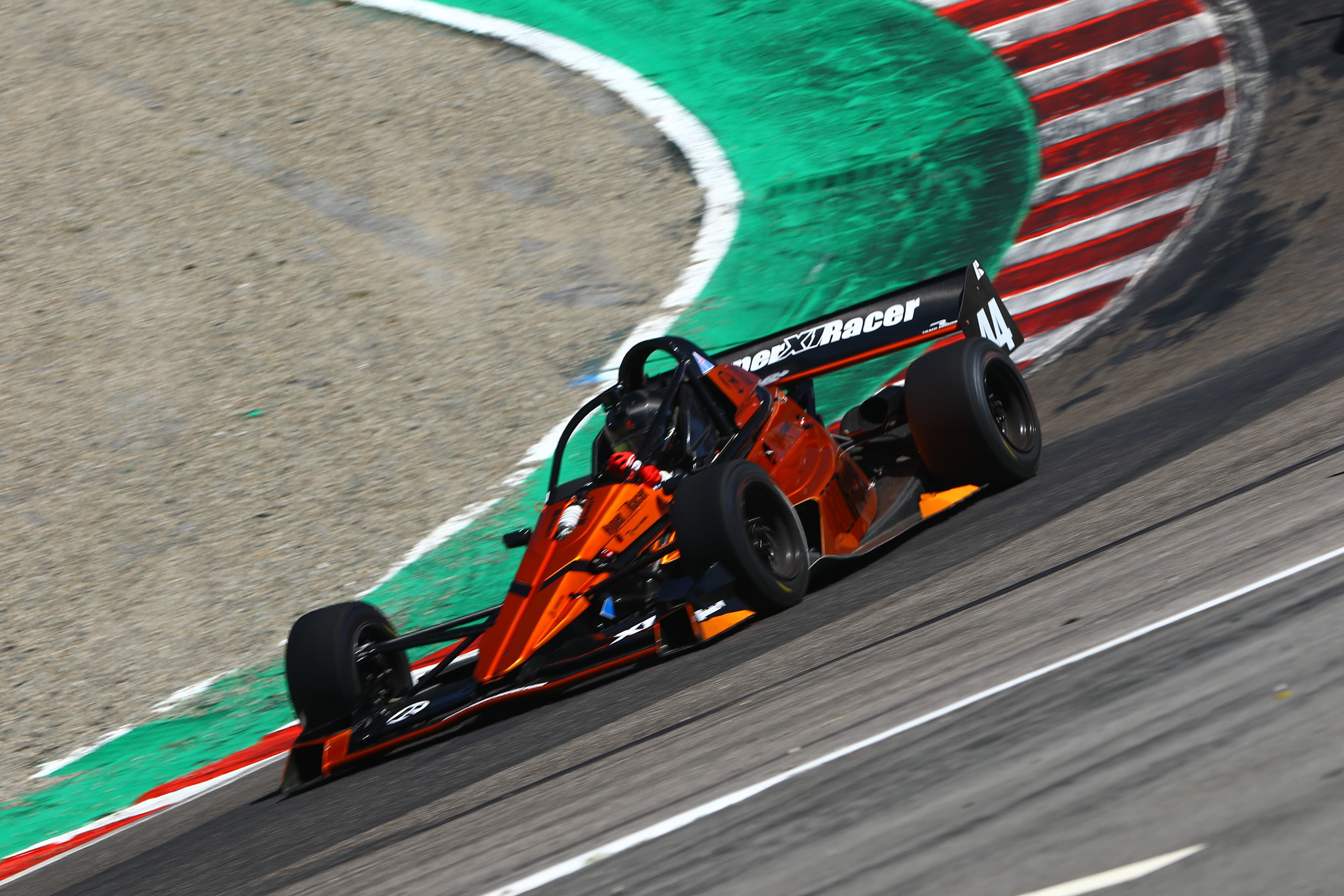 Orange X1 cornering at Laguna Seca